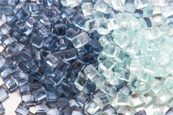 A pile of manufactured clear cubes of polymer.