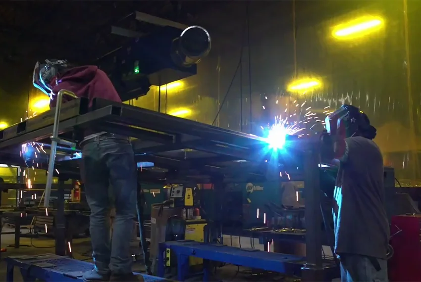 RoboVent's Vista360 dust collector mounted on the ceiling with welding happening below