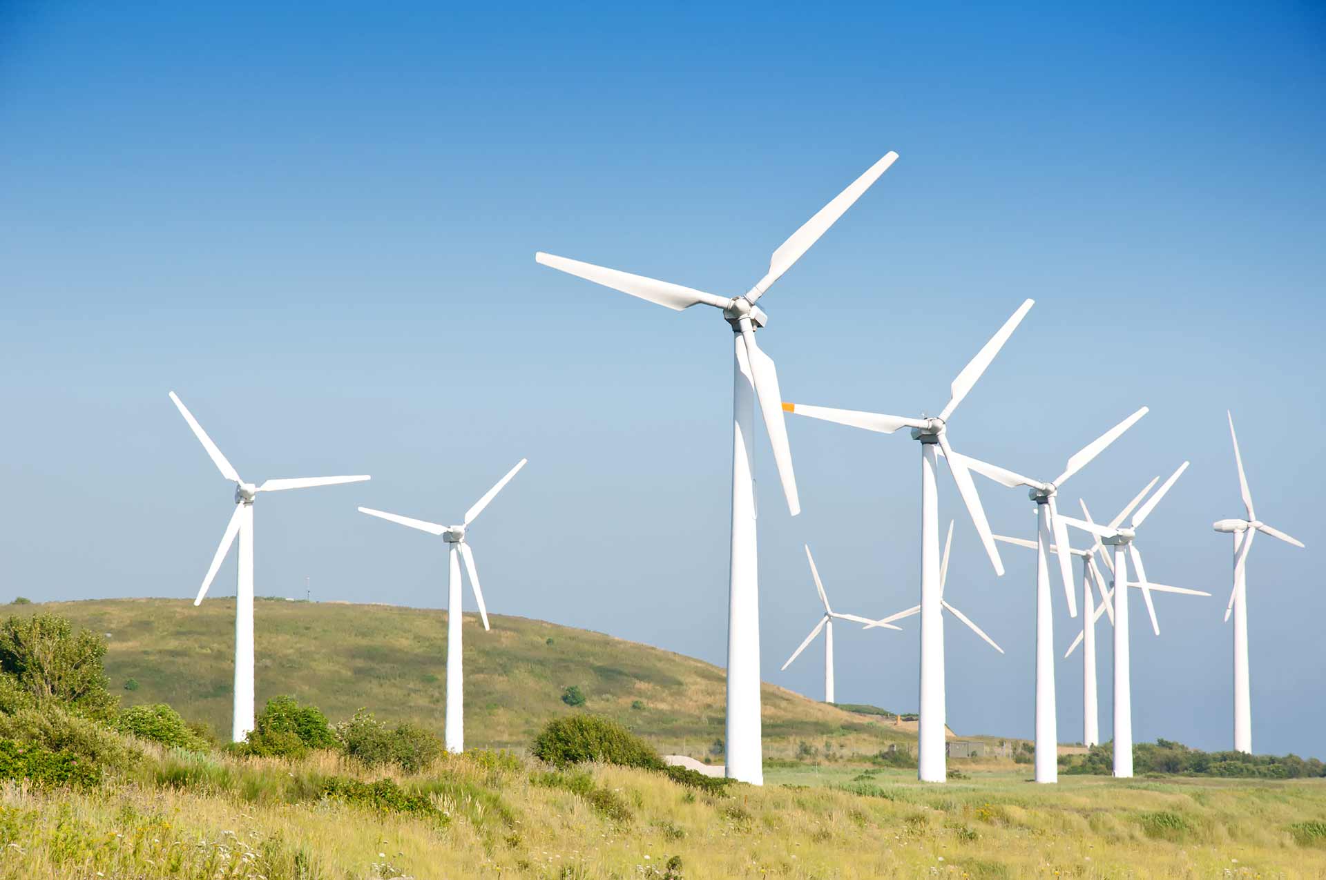 Wind turbine farm with wind turbines manufactured from a facility with dust collection solutions for renewables equipment