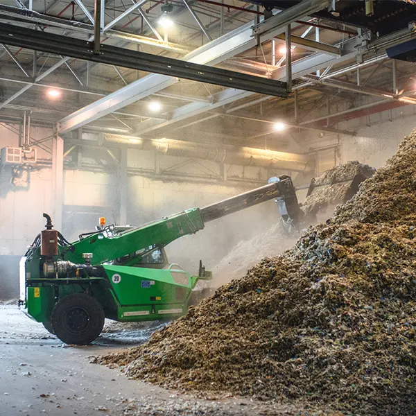 Heavy equipment working in a recycling plant in need of dust collection solutions.