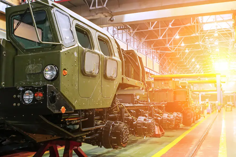 Military vehicles in a large industrial facility