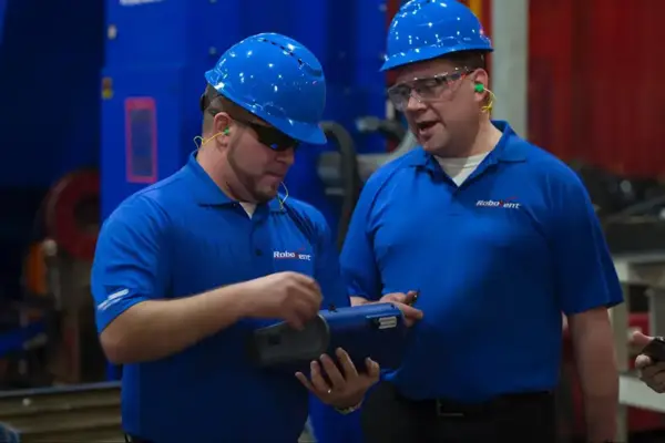 RoboVent technicians discuss facility conditions during an on-site indoor air quality compliance evaluation.