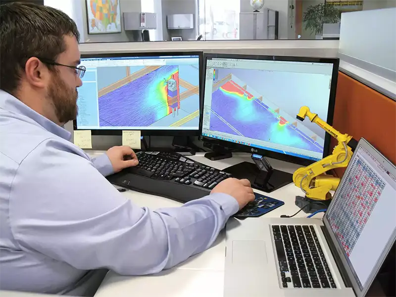 ventmapping RoboVent engineer reviews airflow modeling data to evaluate indoor air quality compliance in an industrial facility.