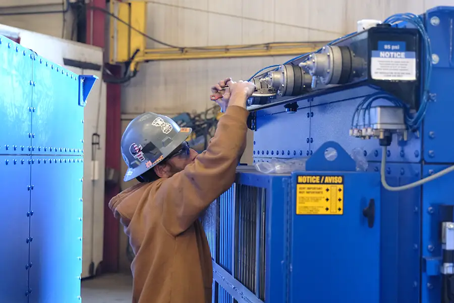 RoboVent technician RoboVent technician performs maintenance and repair work on an industrial dust collection system.